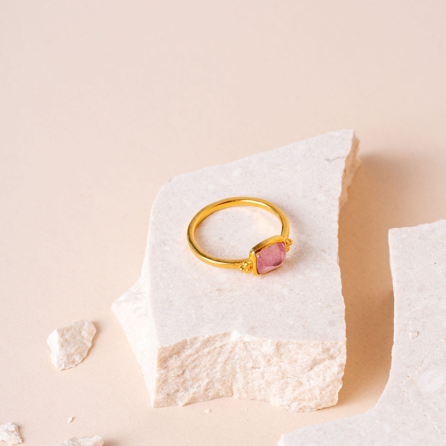 Charming gold ring with delicate granulation and a small, hand-cut light pink tourmaline.