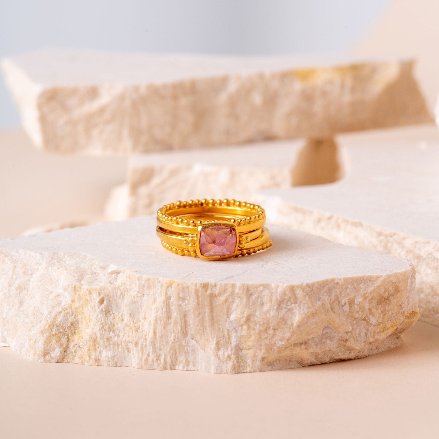 Elegantly crafted gold ring with delicate granulation and a small light pink tourmaline.